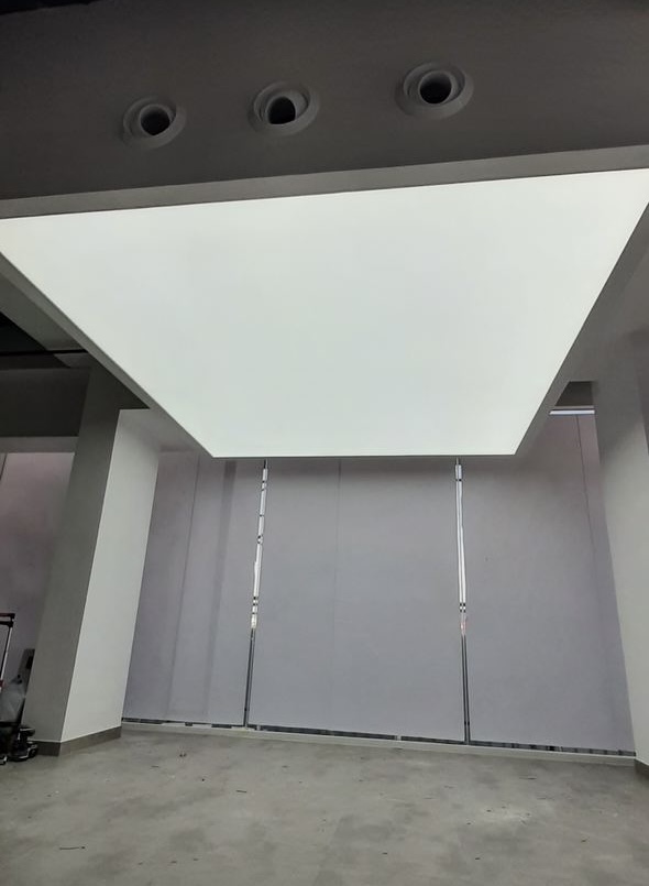 Sagging stretch ceiling membrane caused by heat and installation issues in a commercial interior in the UAE. Sagging stretch ceiling membrane caused by heat and installation issues in a commercial interior in the UAE.