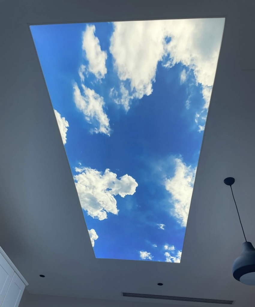 Large rectangular light box ceiling with custom cloud print integrated into a contemporary kitchen interior. The cool white 6500K illumination provides bright natural-style lighting and a relaxing atmosphere. Large rectangular light box ceiling with custom cloud print integrated into a contemporary kitchen interior. The cool white 6500K illumination provides bright natural-style lighting and a relaxing atmosphere.