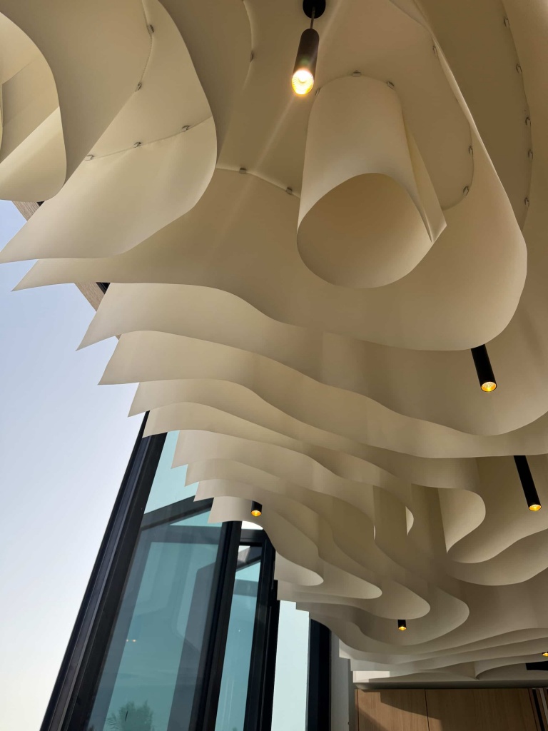 A bespoke 3D fabric ceiling installed in a luxury Dubai villa, featuring flowing sculptural forms and integrated architectural lighting. This custom ceiling transforms the interior into a striking architectural statement while maintaining a clean and elegant contemporary aesthetic. A bespoke 3D fabric ceiling installed in a luxury Dubai villa, featuring flowing sculptural forms and integrated architectural lighting. This custom ceiling transforms the interior into a striking architectural statement while maintaining a clean and elegant contemporary aesthetic.