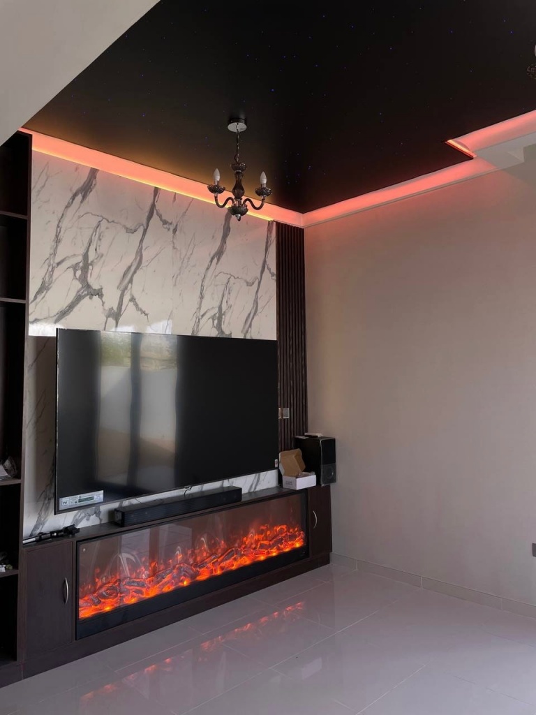 Contemporary villa interior featuring a black star stretch ceiling with customizable RGBW lighting and elegant chandelier integration. The ceiling creates a premium cinematic atmosphere in the living room. Contemporary villa interior featuring a black star stretch ceiling with customizable RGBW lighting and elegant chandelier integration. The ceiling creates a premium cinematic atmosphere in the living room.
