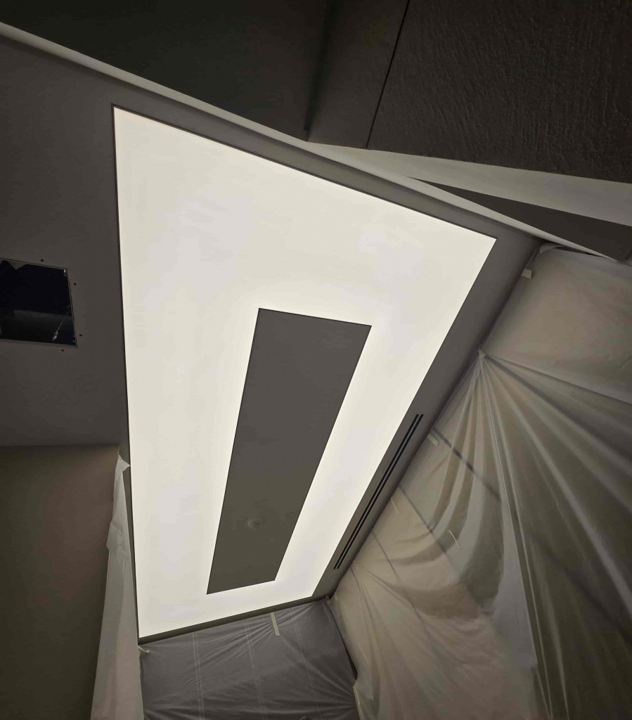 Translucent stretch ceiling with 6500K LED lighting in fitting room at Dubai Hills Mall clothing store
