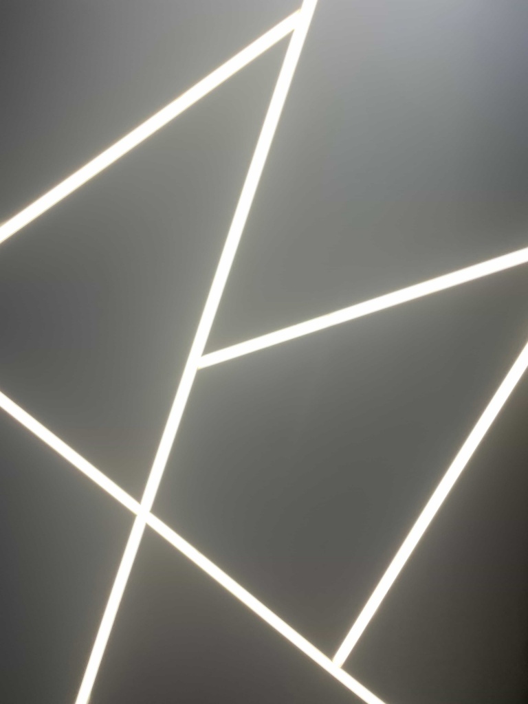 Minimalist linear ceiling lighting design with geometric LED light composition. Minimalist linear ceiling lighting design with geometric LED light composition.