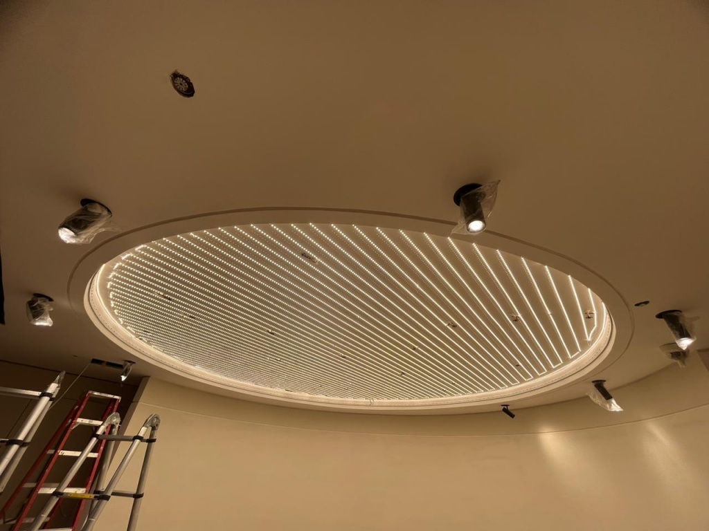 Circular stretch ceiling light box with 4000K LED lighting in dining area of Emirates Hills villa Dubai