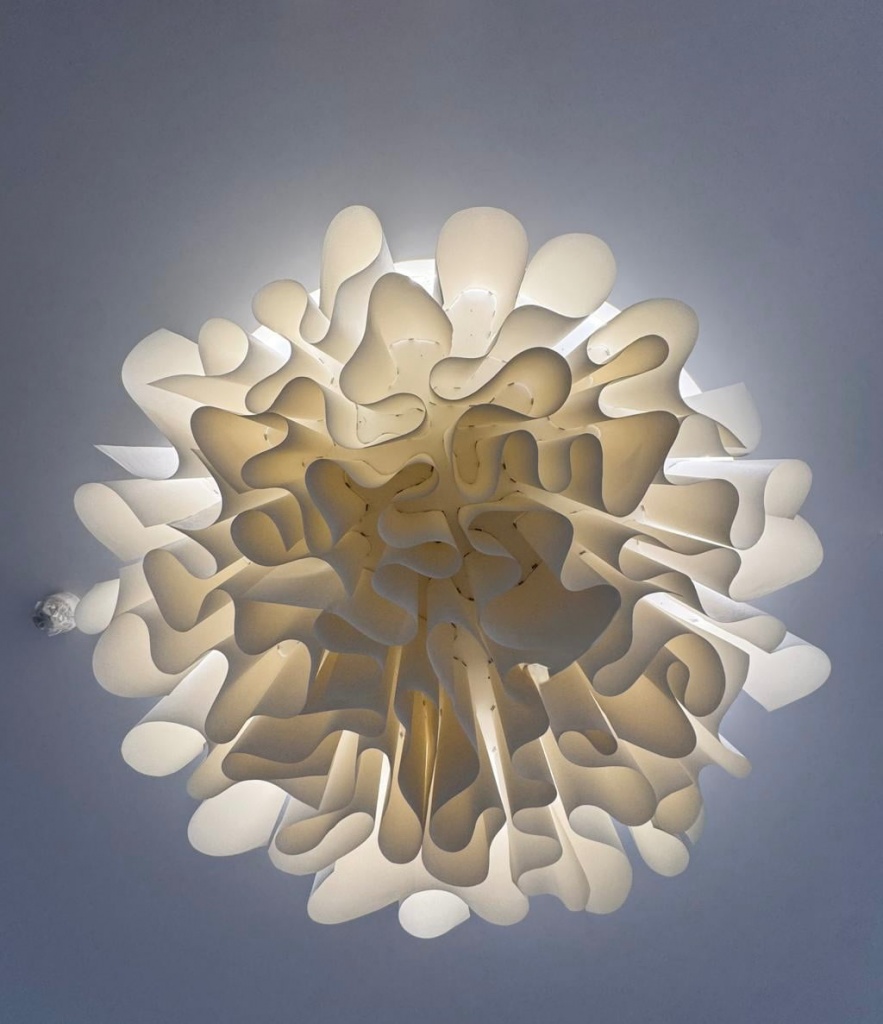 Close-up showing the precision engineering and sculptural fabric forms of a bespoke ceiling installation. Close-up showing the precision engineering and sculptural fabric forms of a bespoke ceiling installation.