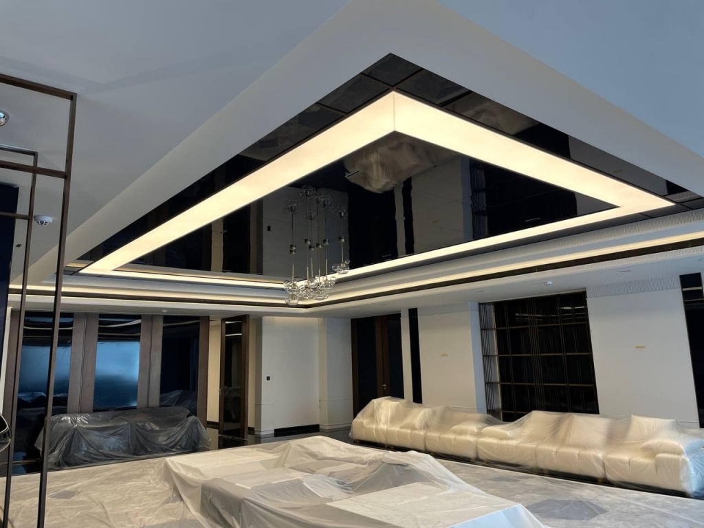 Premium stretch ceiling installation featuring neutral white 4000K lighting and reflective black ceiling surfaces in Emirates Hills. Premium stretch ceiling installation featuring neutral white 4000K lighting and reflective black ceiling surfaces in Emirates Hills.