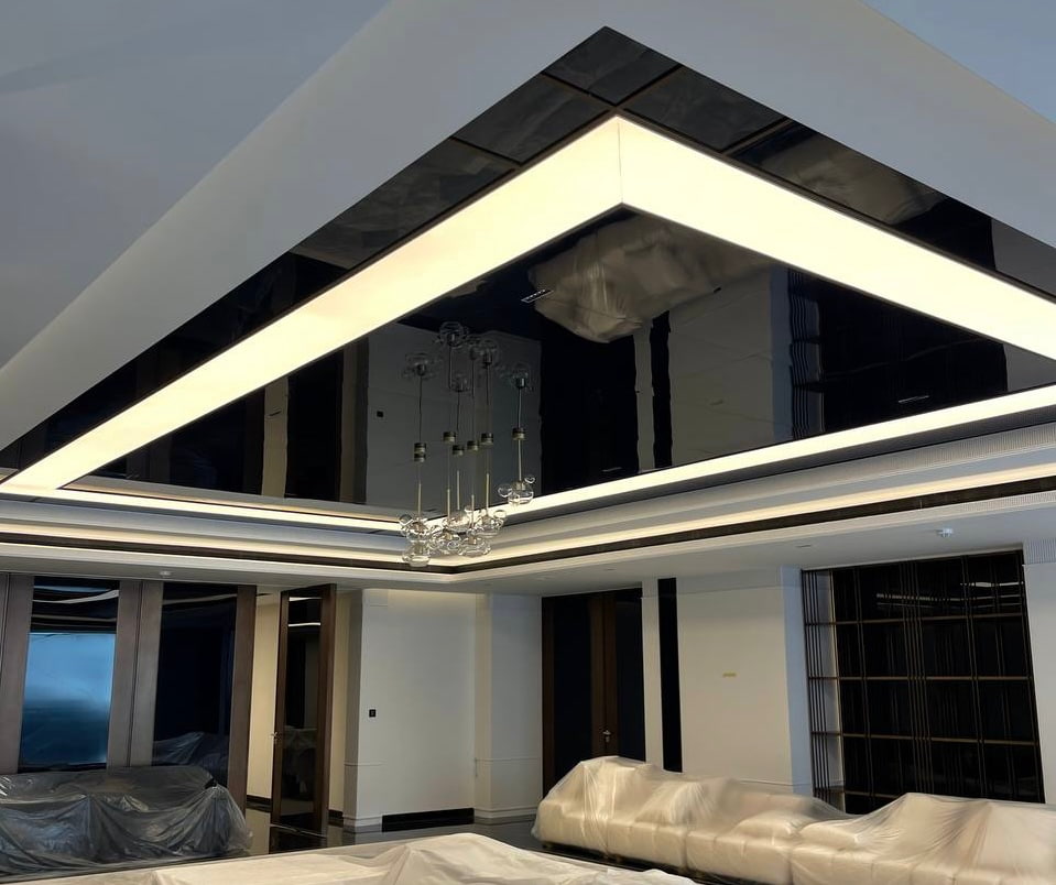 Large 4000K illuminated light box combined with a black gloss stretch ceiling in a luxury villa interior at Emirates Hills. Large 4000K illuminated light box combined with a black gloss stretch ceiling in a luxury villa interior at Emirates Hills.