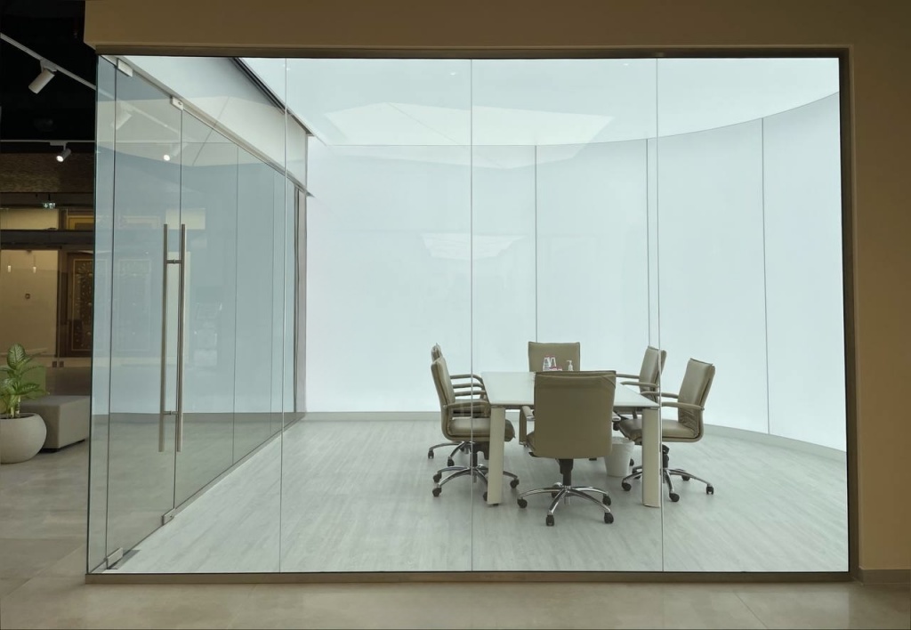 Custom backlit stretch wall and ceiling system creating a seamless illuminated workspace for a commercial meeting room. Custom backlit stretch wall and ceiling system creating a seamless illuminated workspace for a commercial meeting room.