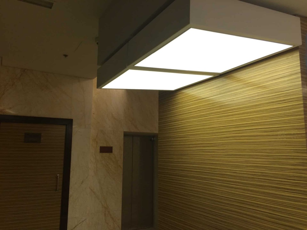 Suspended stretch ceiling light box with LED lighting in modern commercial interior in Dubai