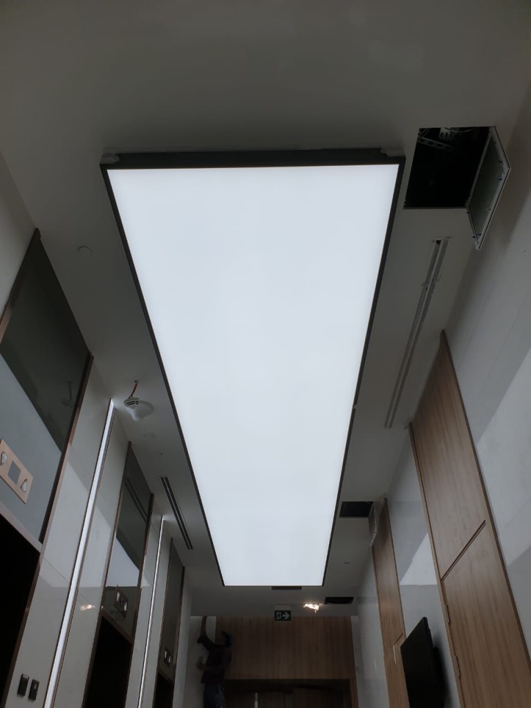 Translucent stretch ceiling light box with 4000K LED lighting installed in a corridor interior in Dubai