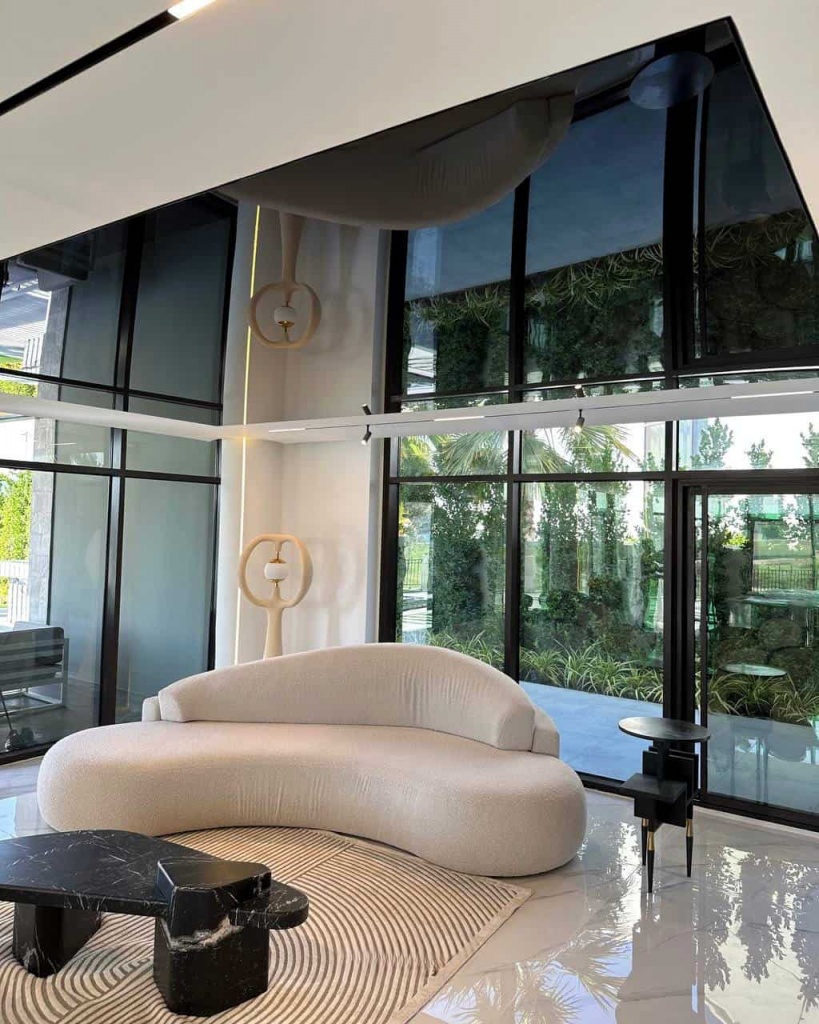 Premium high-gloss black ceiling integrated into a contemporary double-height villa interior with panoramic glazing. Premium high-gloss black ceiling integrated into a contemporary double-height villa interior with panoramic glazing.