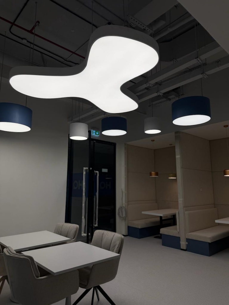 Coworking office lighting in Dubai with integrated LED stretch ceiling system for modern collaborative workspaces Coworking office lighting in Dubai with integrated LED stretch ceiling system for modern collaborative workspaces