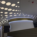 White satin stretch ceiling with decorative circle shape light