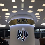 White satin stretch ceiling with decorative circle shape light